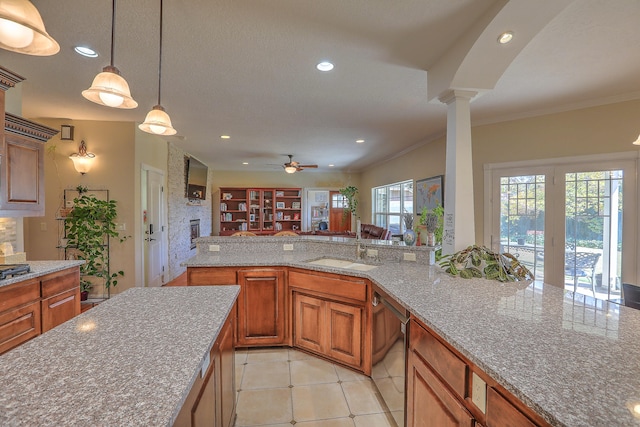 kitchen featuring dishwasher, crown molding, hanging light fixtures, ceiling fan, and ornate columns