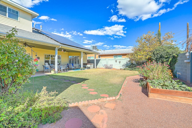 view of yard featuring ceiling fan and a patio area