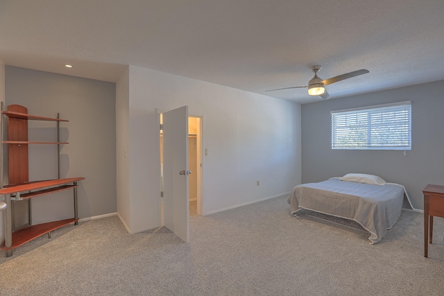 bedroom featuring ceiling fan and light carpet