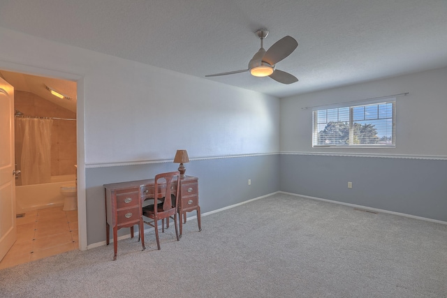 unfurnished office featuring carpet flooring, ceiling fan, a textured ceiling, and lofted ceiling