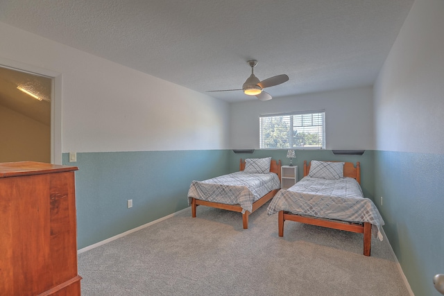 carpeted bedroom with a textured ceiling and ceiling fan