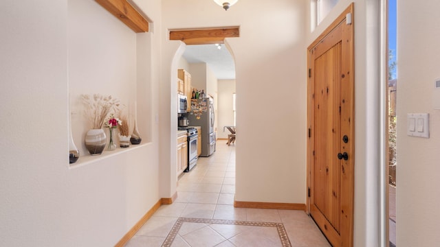 hall with light tile patterned flooring and a wealth of natural light