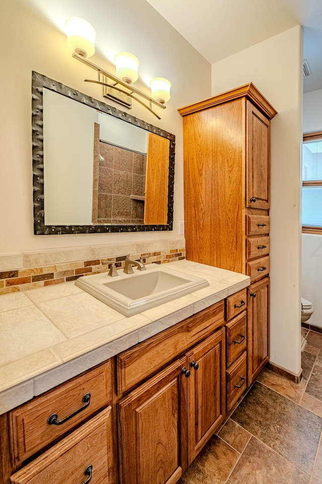 bathroom with vanity and toilet