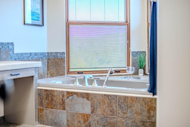 bathroom with a relaxing tiled tub