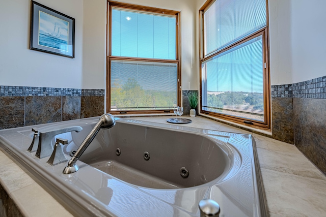 bathroom featuring a relaxing tiled tub