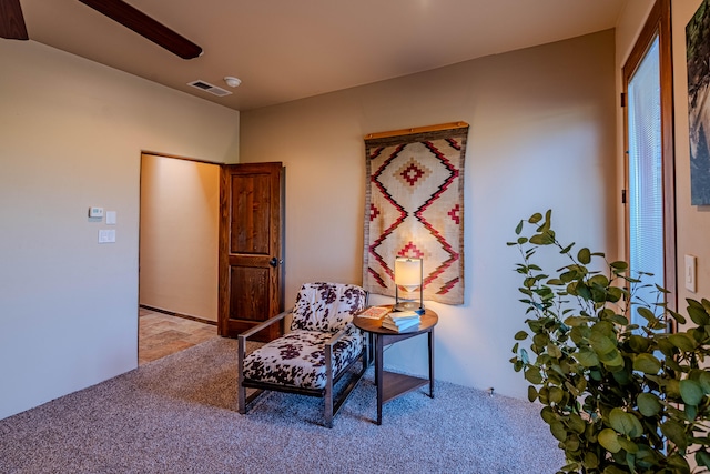 living area featuring light carpet