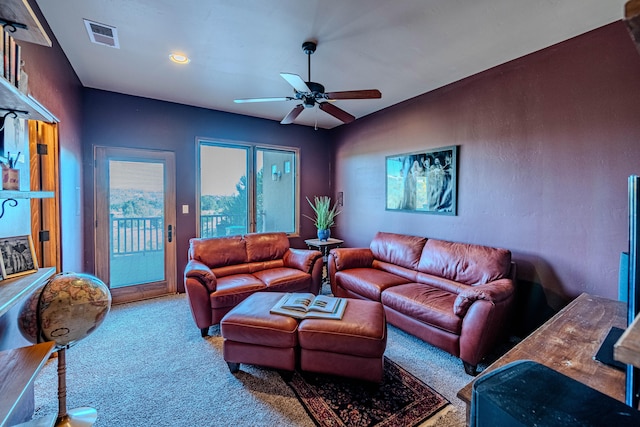 carpeted living room featuring ceiling fan