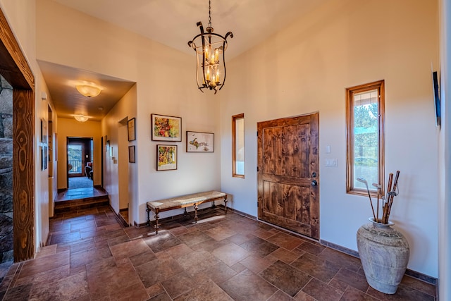 entryway featuring a notable chandelier and a high ceiling