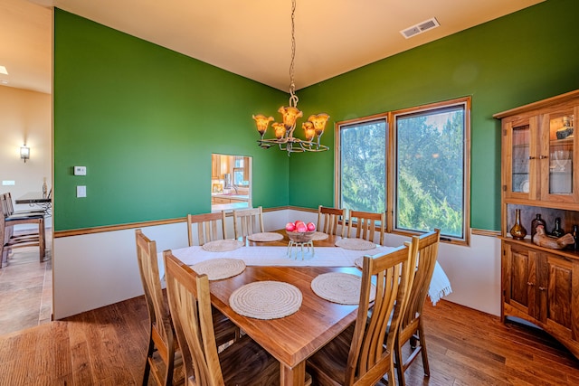 dining room with a chandelier and hardwood / wood-style flooring