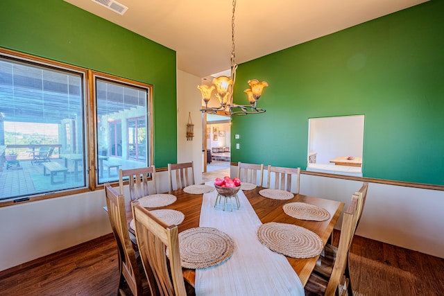 dining space with a chandelier and dark wood-type flooring