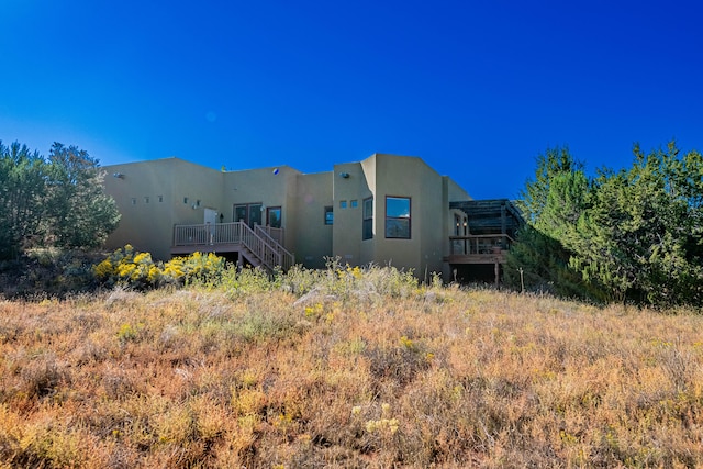 rear view of property featuring a deck