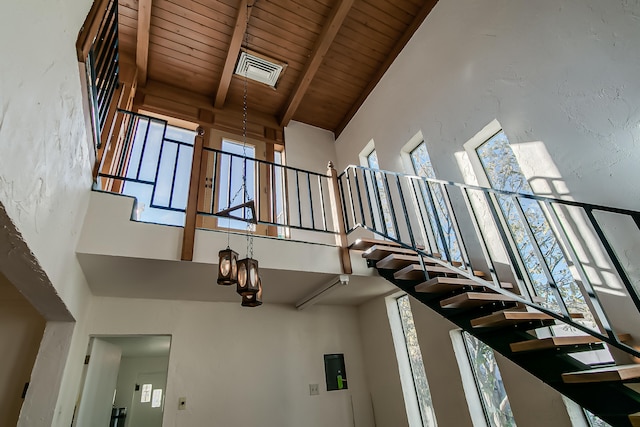 interior space featuring beamed ceiling, wood ceiling, and high vaulted ceiling