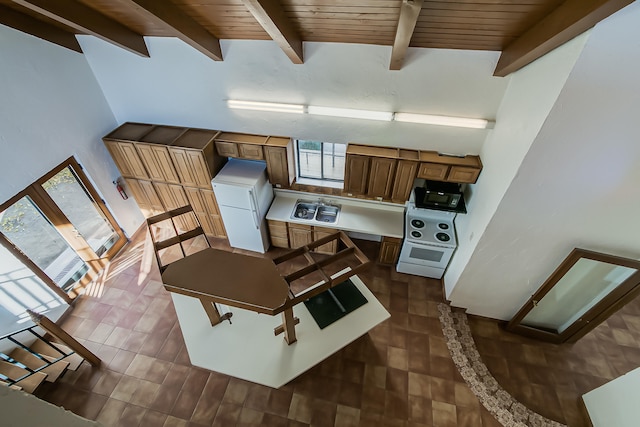 kitchen featuring beam ceiling, high vaulted ceiling, wood ceiling, and white appliances