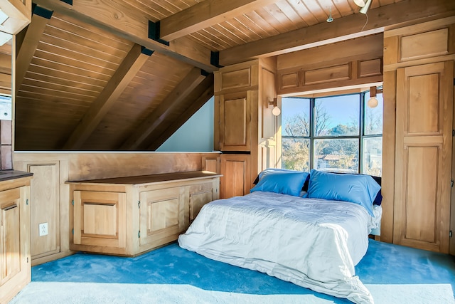 unfurnished bedroom with vaulted ceiling with beams, wooden ceiling, and light carpet