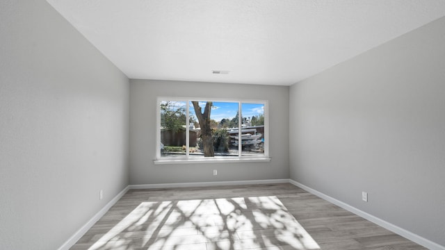 empty room with light hardwood / wood-style flooring