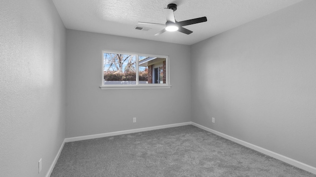 carpeted spare room with ceiling fan and a textured ceiling