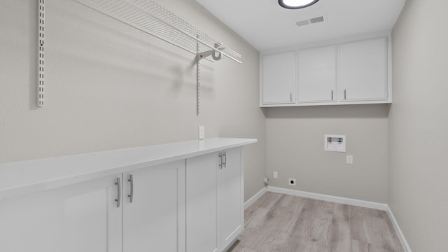 laundry area with cabinets, light wood-type flooring, and hookup for a washing machine