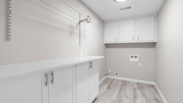 laundry area with washer hookup, hookup for an electric dryer, cabinets, and light wood-type flooring