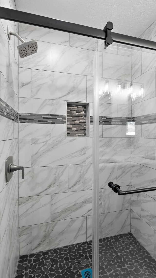 bathroom with a shower with shower door