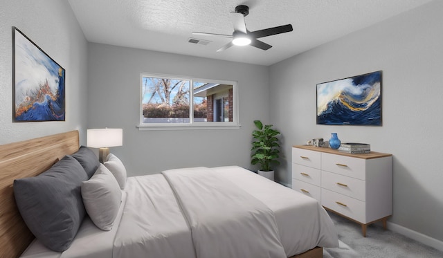 carpeted bedroom with a textured ceiling and ceiling fan