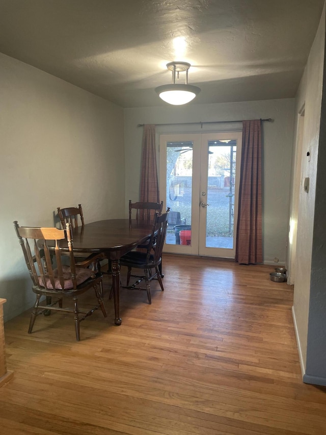 dining area featuring french doors and wood-type flooring