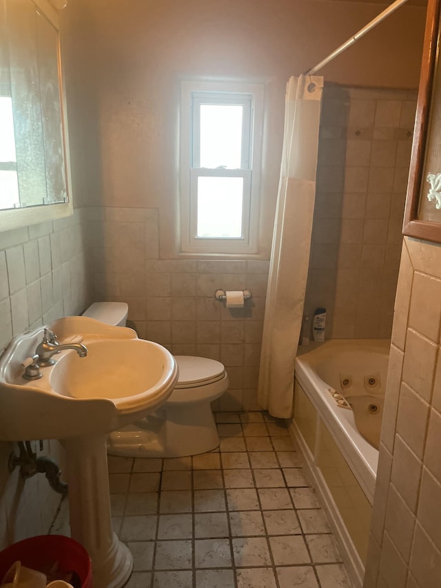 bathroom with toilet, shower / bathtub combination with curtain, and tile walls