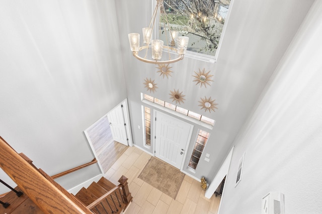 entryway with a chandelier