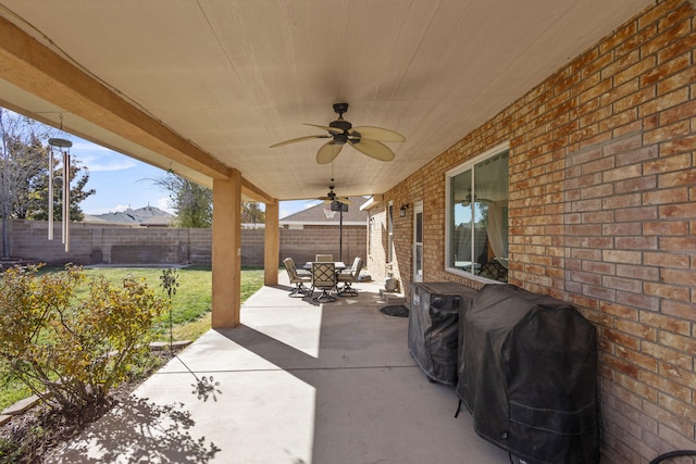 view of patio with ceiling fan and a grill