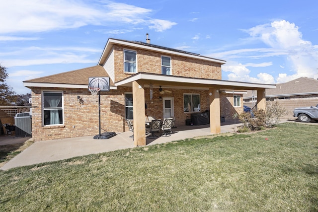 back of house with a yard, a patio area, and ceiling fan