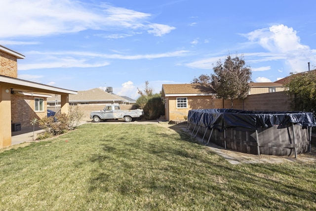 view of yard featuring a covered pool