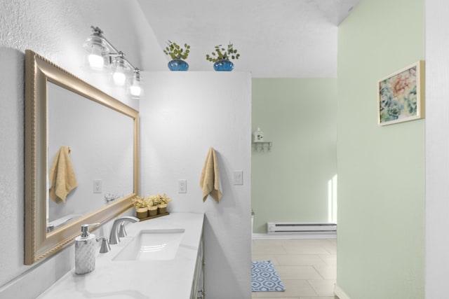 bathroom featuring vanity, a baseboard heating unit, and tile patterned floors