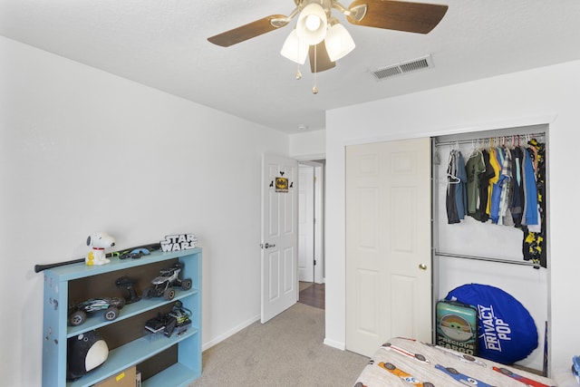 carpeted bedroom with a closet and ceiling fan