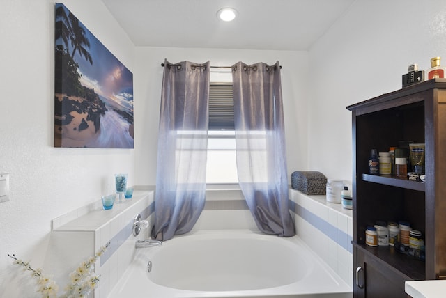 bathroom with a tub to relax in