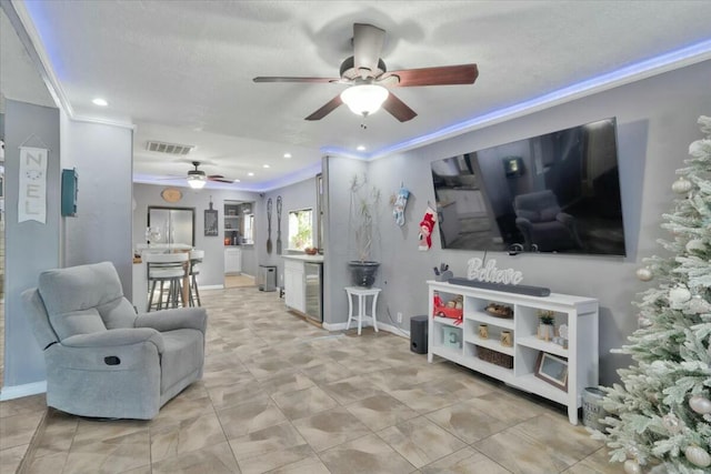 121 Hosher Ave SE, Albuquerque, NM 87102 - living room featuring a ceiling fan, recessed lighting, and ornamental molding