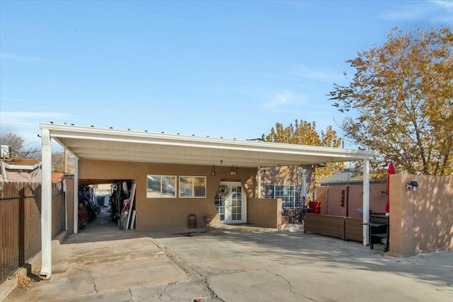 121 Hosher Ave SE, Albuquerque, NM 87102 - back of house featuring an attached carport and stucco siding