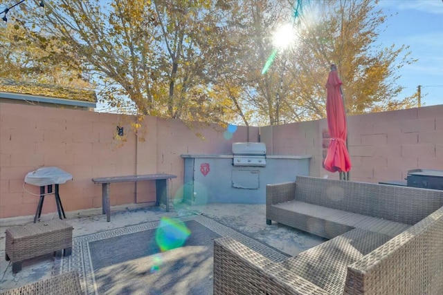 view of patio / terrace with an outdoor living space, area for grilling, and a grill