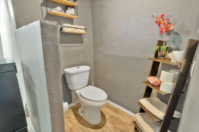 121 Hosher Ave SE, Albuquerque, NM 87102 - bathroom with toilet and wood finished floors