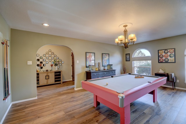 playroom featuring billiards, baseboards, arched walkways, light wood-type flooring, and a chandelier