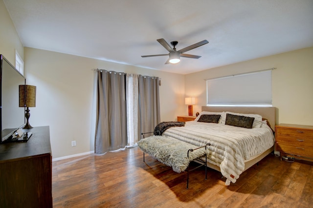 bedroom with baseboards, a ceiling fan, and wood finished floors