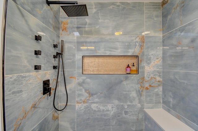 full bath featuring tiled shower