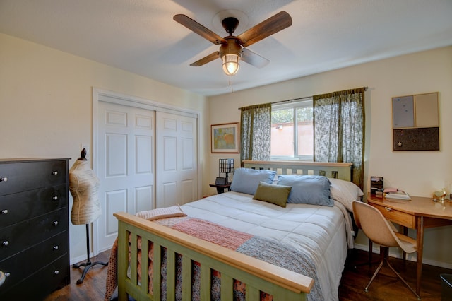 bedroom featuring dark wood finished floors, baseboards, a closet, and a ceiling fan