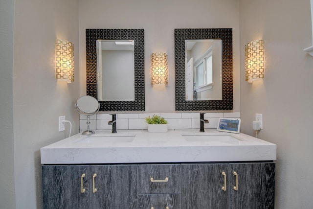 bathroom featuring a sink, decorative backsplash, and double vanity