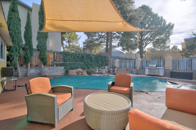 view of swimming pool featuring a patio area, a fenced in pool, and a fenced backyard