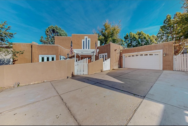 pueblo-style home with a garage