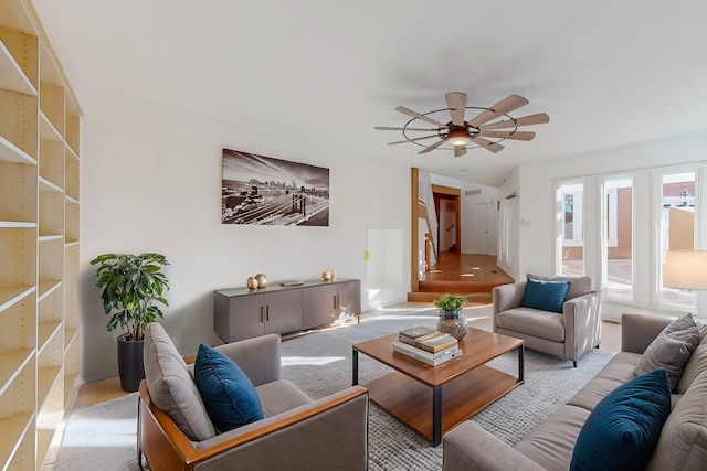 living room featuring ceiling fan and light hardwood / wood-style floors