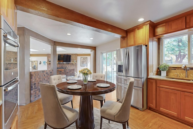 kitchen with stainless steel fridge, sink, stainless steel refrigerator, and light parquet flooring