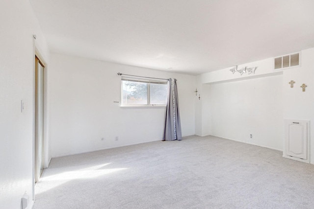 unfurnished room with light colored carpet