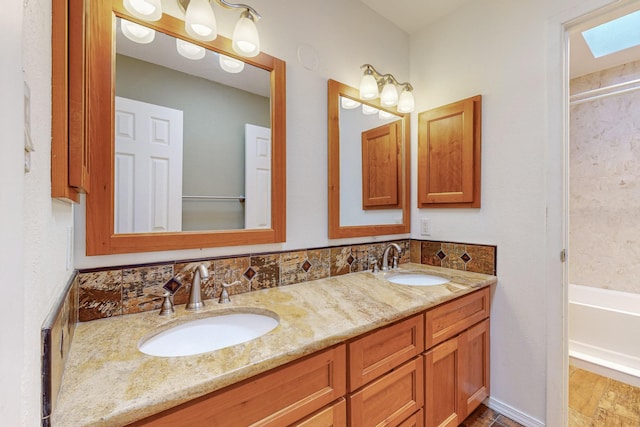 bathroom with a skylight, vanity, and wood-type flooring