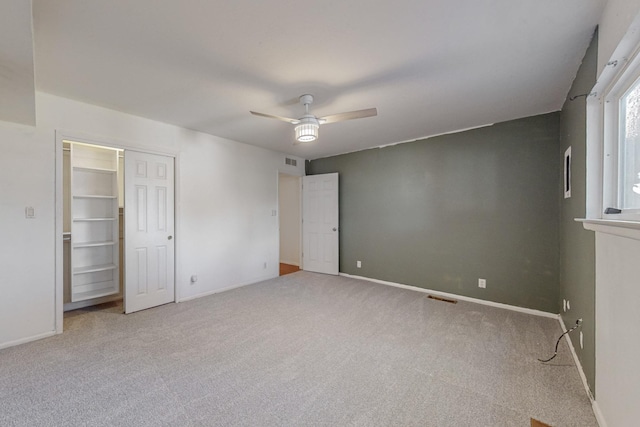 unfurnished bedroom with ceiling fan and light colored carpet