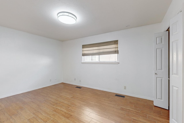 spare room featuring light hardwood / wood-style floors